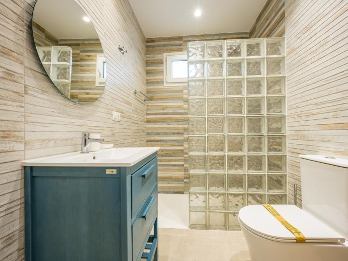 Family bathroom with rainhead shower, toilet, sink and mirror on the groundfloor