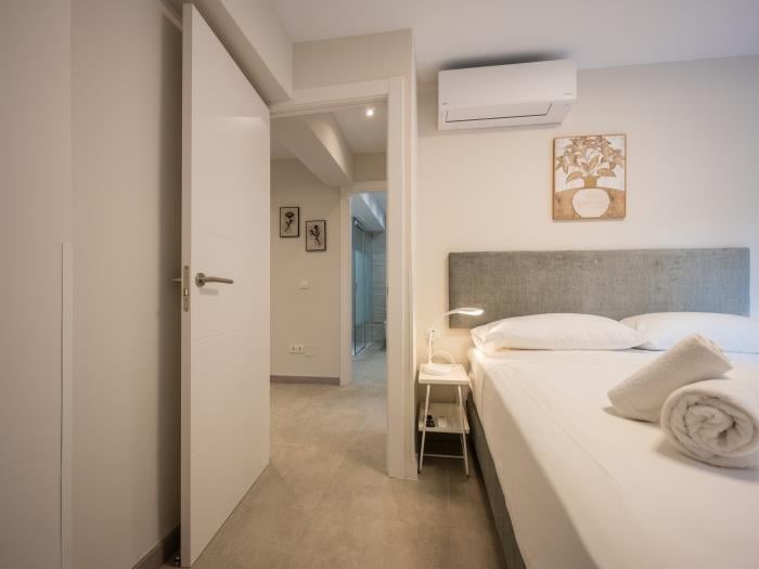 Nightsands with lamp, air conditioners and flatscreen TV