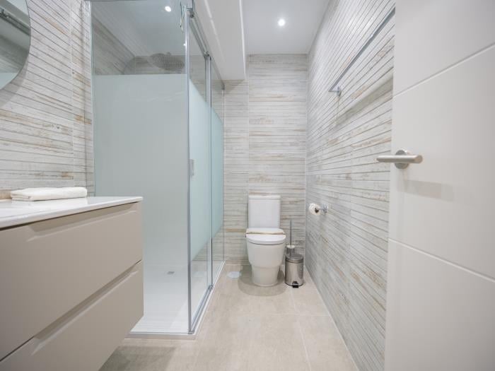 Family bathroom with rainhead shower, sink and toilet
