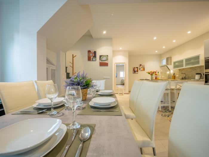 Modern finishings in spacious living room with dining area for 8 and sitting area with leather sofas