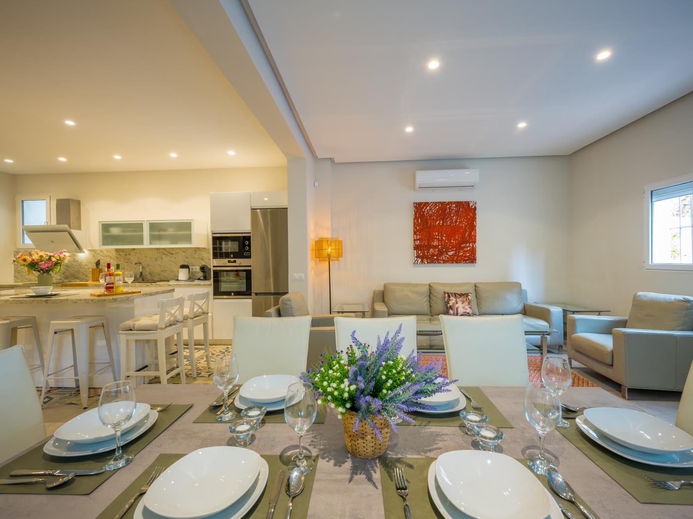 Dining area with upholstered comfortable leather chairs for eight guests