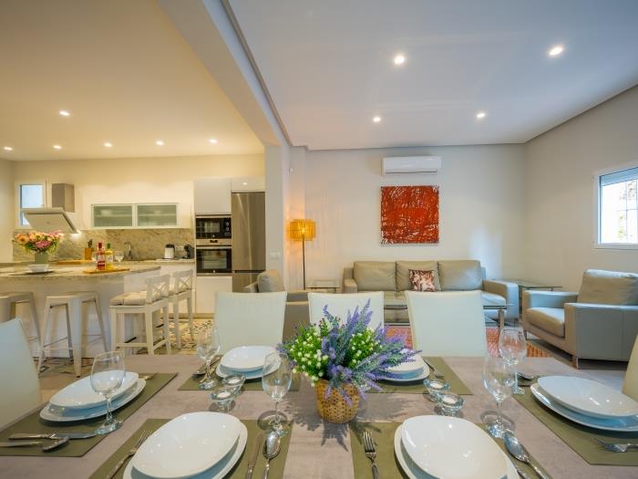 Dining area with upholstered comfortable leather chairs for eight guests
