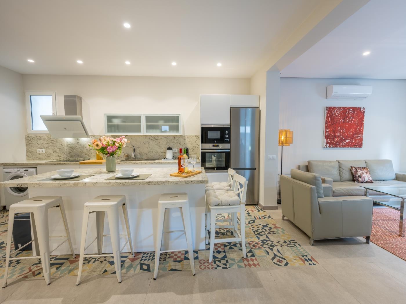 Sitting area with leather sofas around glass coffee table and dining area with table for 8